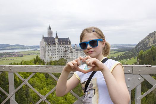 small tourist on the bridge, the view of Neuschwanstein Castle