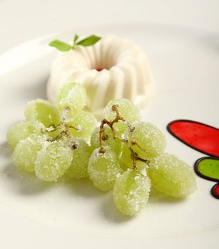 Close up Panna Cotta with grapes and sugar