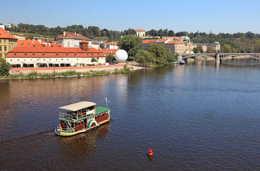 Small touristic ship on the river in Prague.