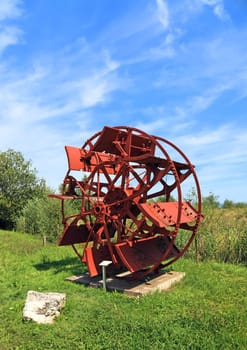 Watermill wheel made of metal. Switzerland, Europe.