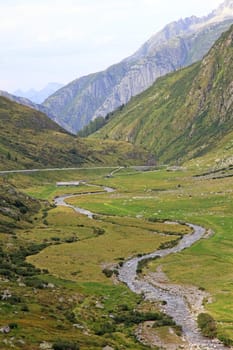 Small river among swiss Alps, Europe.