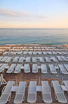 Lot of deck-chairs at the beach of city of Nice, France, Cote d'Azur.