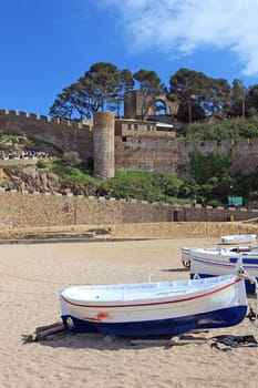 Boats on the beach in Tossa de Mar, Costa Brava, Spain.