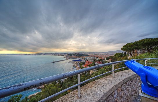 Wide angle panoramic view of harbor of Nice city, France. Dramatic sky before sunset during springtime.