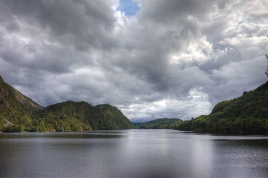 Norwegian lake and dramatic sky, Europe.