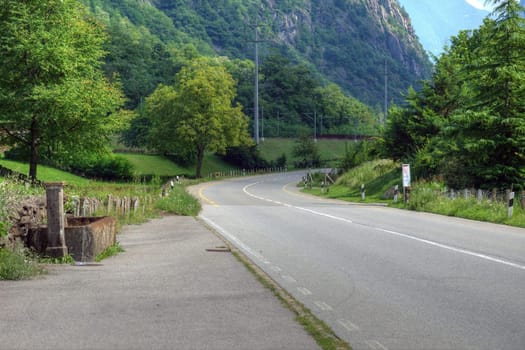 Beautiful rural road in swiss Alps, Europe.