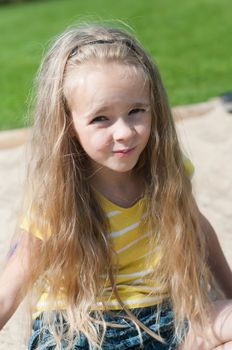 Beautiful little girl with long hair  watching on you