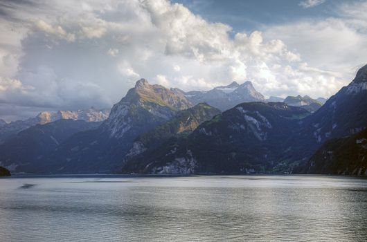 Picturesque swiss lake and alps before sunset, Switzerland, Europe.