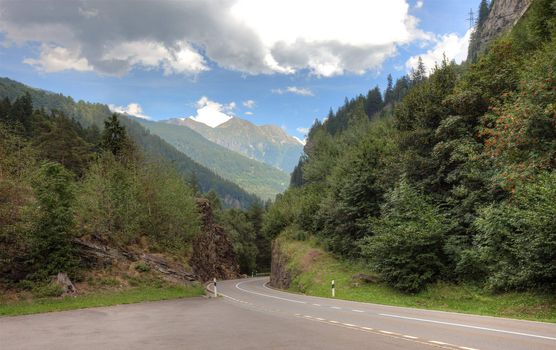 Empty picturesque road in swiss Alps, Europe.