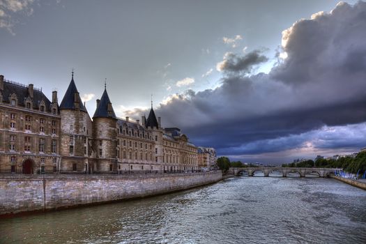 Conciergerie before rain in Paris, dramatic cloudscape.