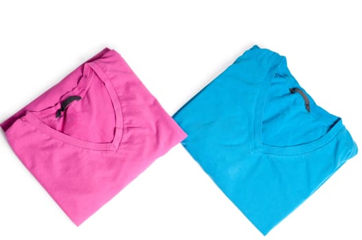 Two t-shirts, pink and blue isolated on white