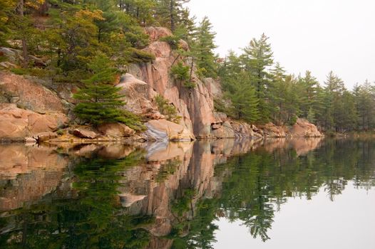 Shore of Killarney Lake in overcast day
