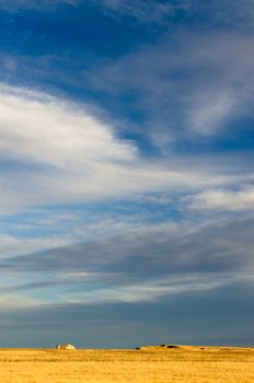 Sky full of clouds above grasslands, Badlands National Park, South Dakota, USA