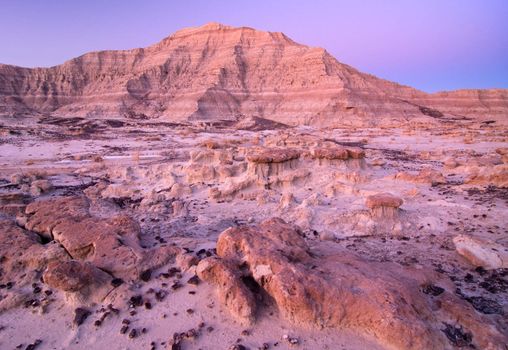 Small caprock formations and eroded ridges at twilight, Badlands National Park, South Dakota, USA