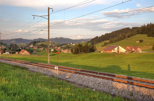 Railroad in swiss Alps before sunset.