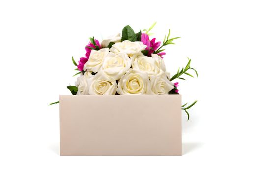 Bunch of roses and textured blank envelope isolated on white background.