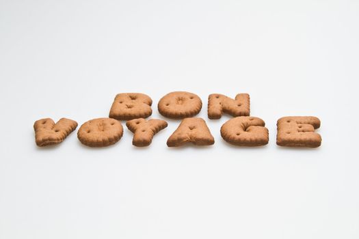 angled view of the phrase bon voyage made by brown biscuits arrangement on white surface