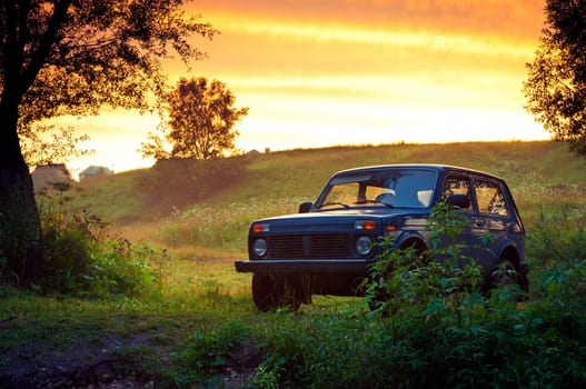 Blue SUV on a beautiful sunset