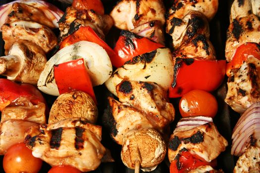 skewered meat and vegetables on a grilling pin ready to be grilled.