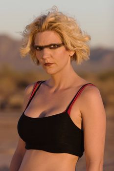 Female science fiction model in a desolate location with dark eye makeup.