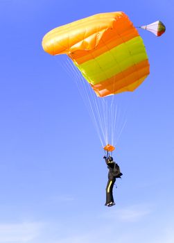 an orange parachute in a blue sky on a sunny day