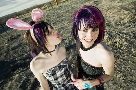 Punk girl sticking her tongue out at her friend