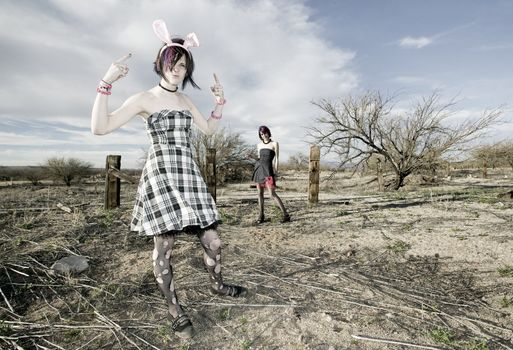 Two punk girls posing in a rural setting