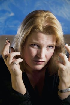 Close up of frustrated blonde woman in a studio. 