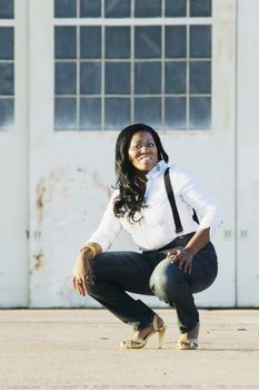 Medium shot of an African American woman at an airplane hangar.