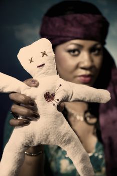 Gypsy fortune teller with an unfortunate voodoo doll.