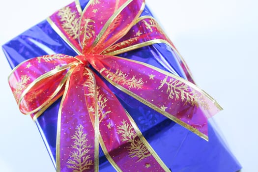 Elegant dark blue present wrapped with red ribbons