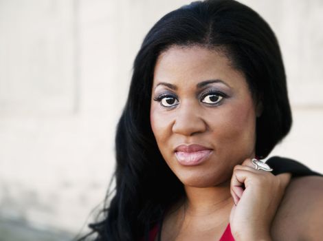 African America business woman in front of an industrial building.