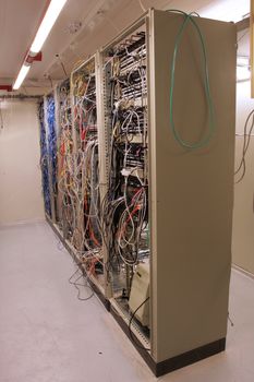 chaotic mess of network cables in a network routing room