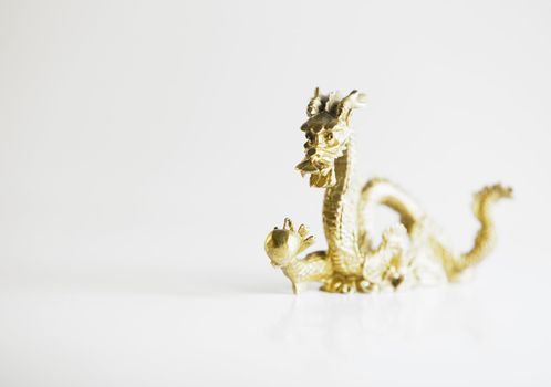 Isolated Ornate Golden Chinese Dragon Holding a Ball
