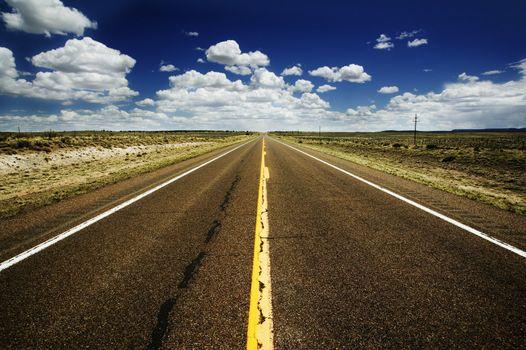 Rural highway heads off to the vanishing point.