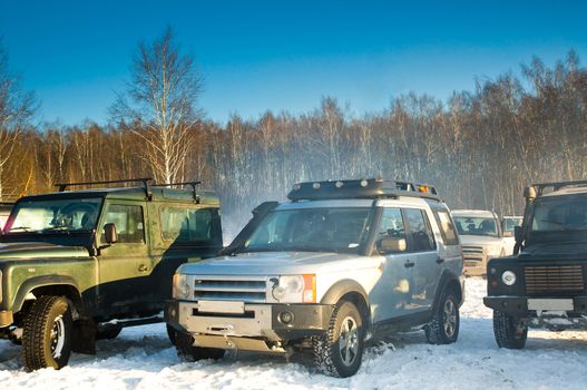 Land Rover Discovery and two Defender.
Three SUV on background the Russian winter.