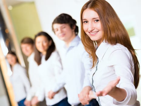 group of people holding hands, woman holds out her hand, the concept of teamwork