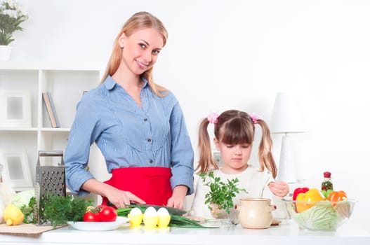 Mother and daughter cooking together, help children to parents