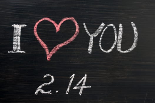 Love with valentine 's date drawn in chalk on a chalkboard