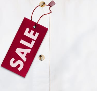 Red Sale Sign on White Shirt - With Copyspace
