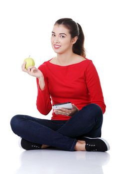 Woman with apple and tablet computer. Isolated on white background.