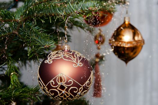 Decorative Christmas balls hanging on pine - tree branch
