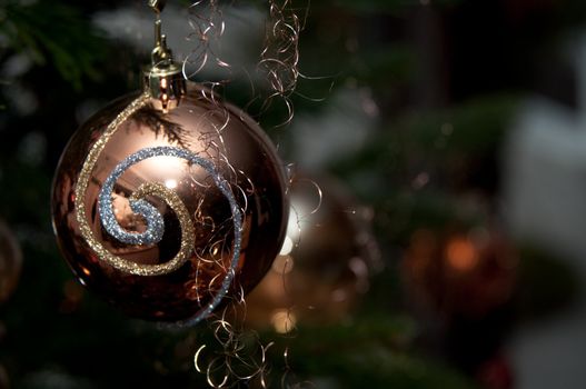 Decorative christmas ball hanging on pine - tree branch