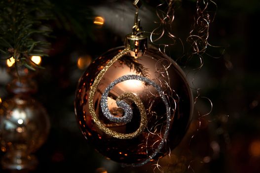 Decorative christmas ball hanging on pine - tree branch