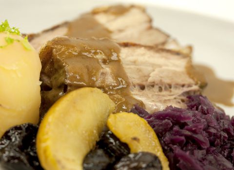 Pork ribs with red sauerkrat cabbage, potatoes, prunes, apples, and brown creamed sauce