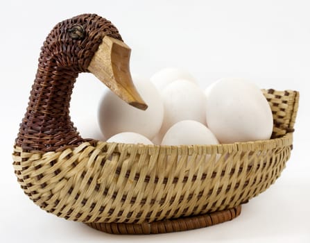 Vintage retro duck shaped basket filled with eggs 