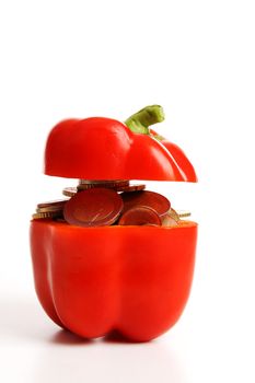 Bell pepper filled with money over white