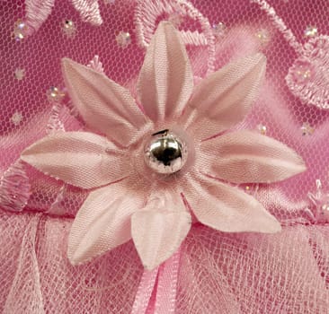 Pink flower detail, with embroidery, lace and satin background