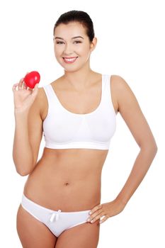 Happy Fit female in white sport underwear with red heart shaped toy