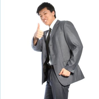 Successful stylish young Asian businessman giving thumbs up of approval and victory, three quarter studio portrait isolated on white
